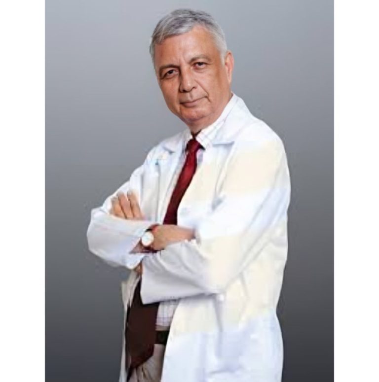 Dr. Ashok Sarin, senior nephrologist, posing confidently in a white coat with arms crossed.